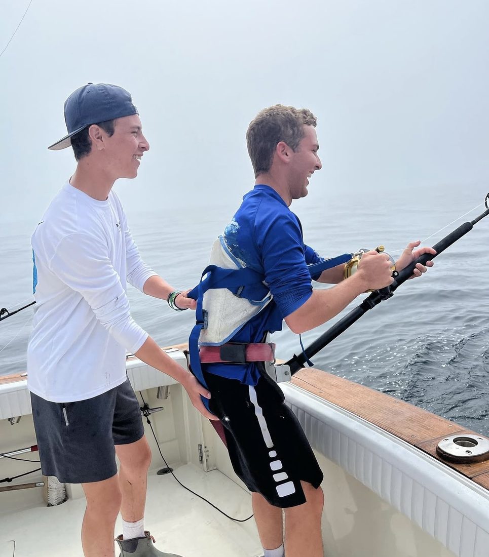 Anglers fighting a tuna offshore