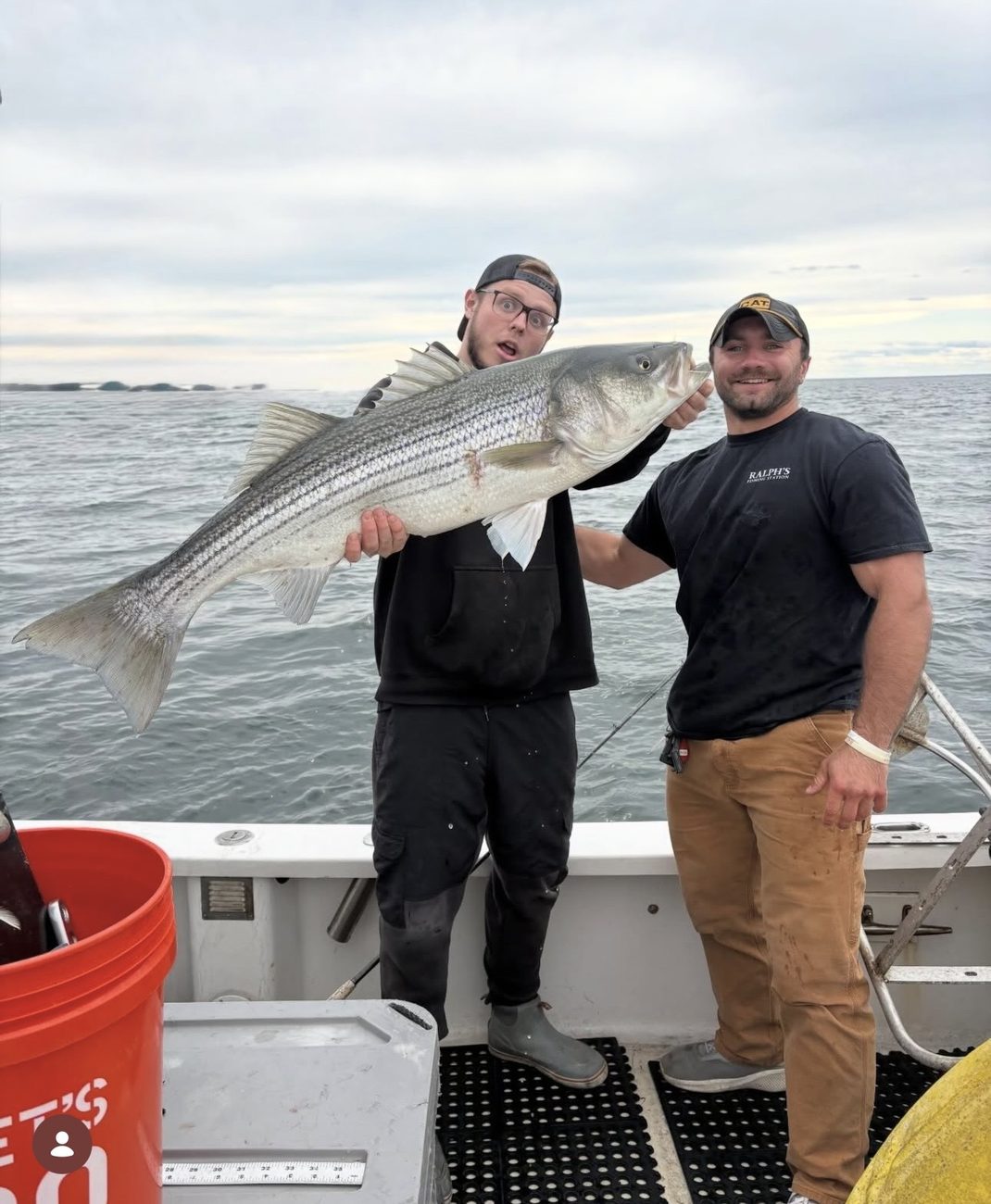 Capt. Renz and a guest with a trophy striped bass aboard Chief